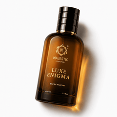 Elegant bottle of Luxe Enigma 100ML perfume by Majestic Perfumes India with intricate gold accents and clear glass design.